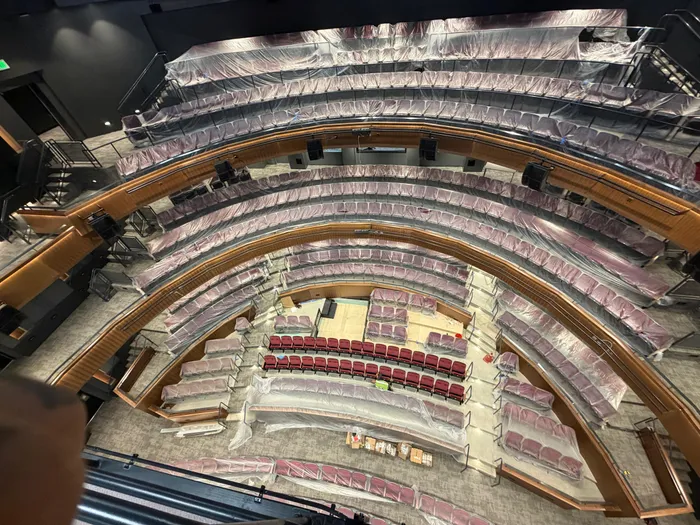 Fan-shaped theater seating with the front row unwrapped