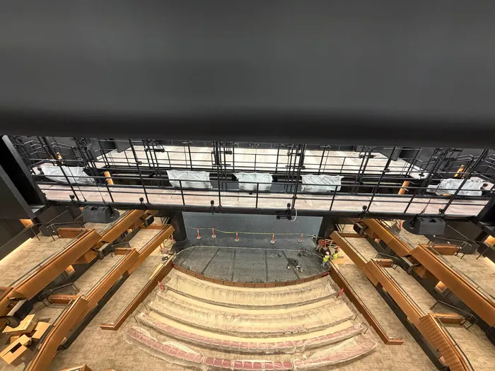 Overlook of the tiered theater balconies during final cleanup