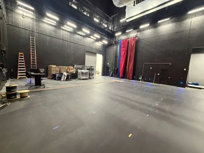 Scene shop floor with curtains and equipment staged